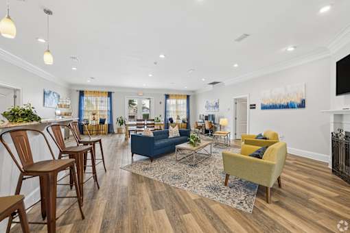 A living room with a blue couch and yellow armchair.