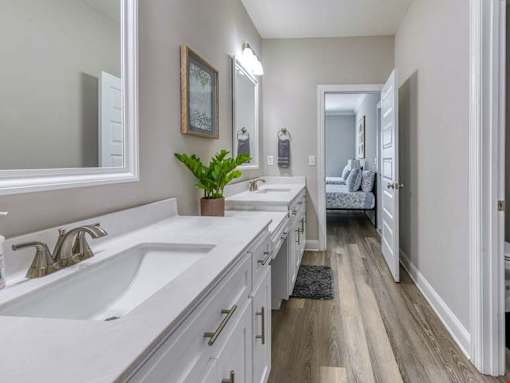 A bathroom with two sinks and a mirror.