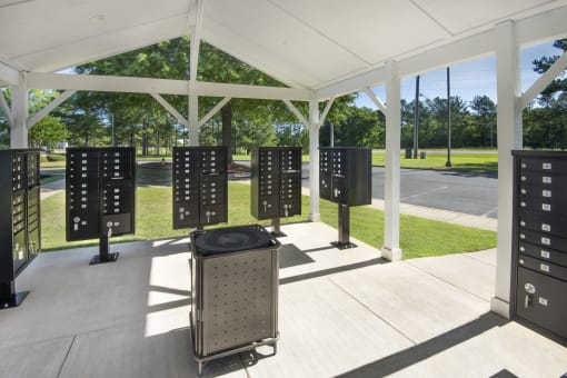 a group of servers in a pavilion with trees in the background