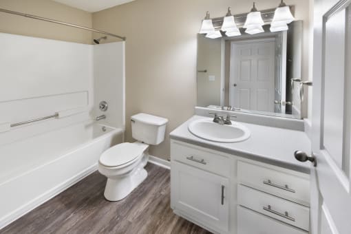 a bathroom with a sink toilet and a bath tub