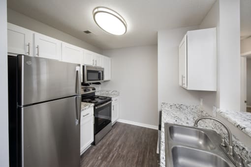 a kitchen with stainless steel appliances and granite counter tops
