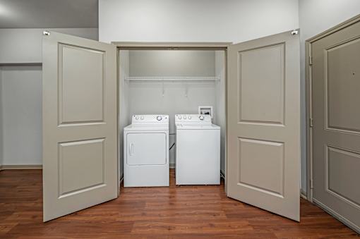 Two washing machines are in a laundry room.