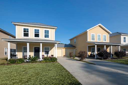 Two houses with a driveway in between.