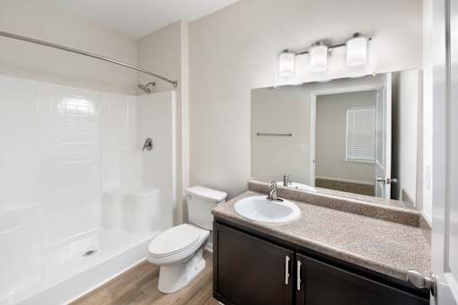 A white toilet sits next to a sink in a bathroom.