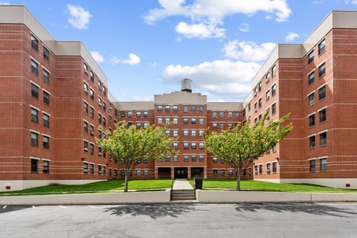 a large brick building with trees in front of it
