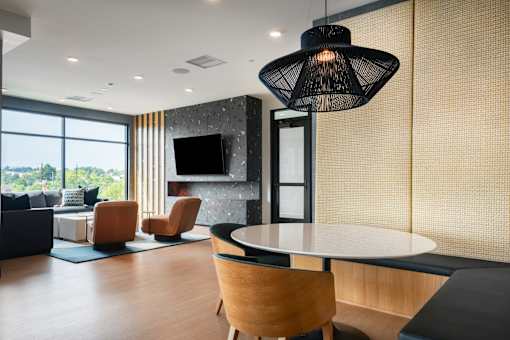 A modern living room with a large window and a flat screen TV.
