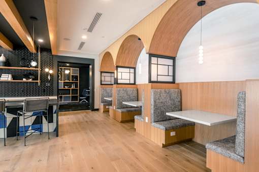 A modern cafe with wooden floors and furniture.