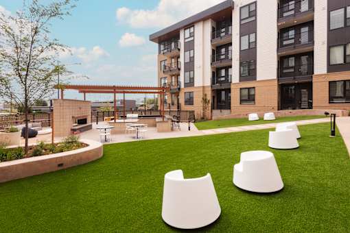 A modern building with a grassy area in front of it.