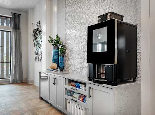 A black microwave oven is on a white cabinet.