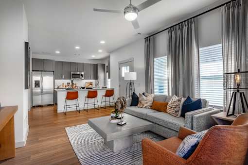 A modern living room with a grey couch and a grey coffee table.