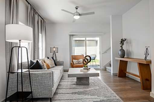 a living room with a gray couch and a coffee table