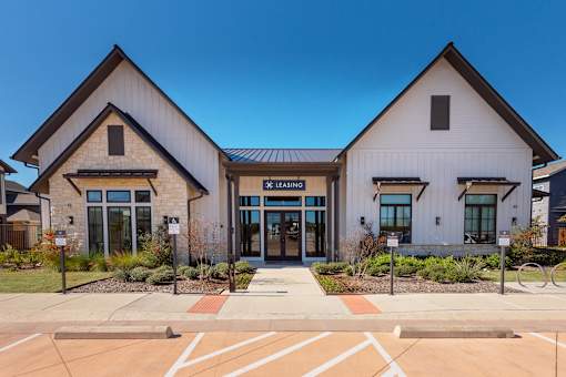 A building with a sign that says "LEASING" is the focal point of the image.