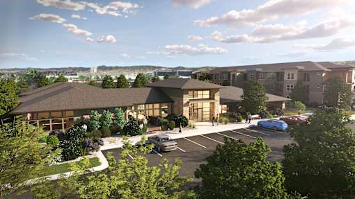 A rendering of a modern building with a parking lot in front.