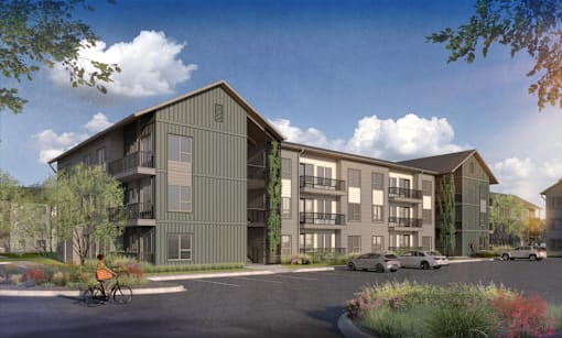 A modern apartment complex with a bicycle parked in front.