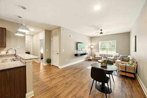 A kitchen with a dining table and chairs in the middle of the room. at Beau Chene Lake Charles Apartments, Lake Charles, 70605