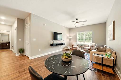 A living room with a black table and chairs at Beau Chene Lake Charles Apartments, Los Angeles, 70605