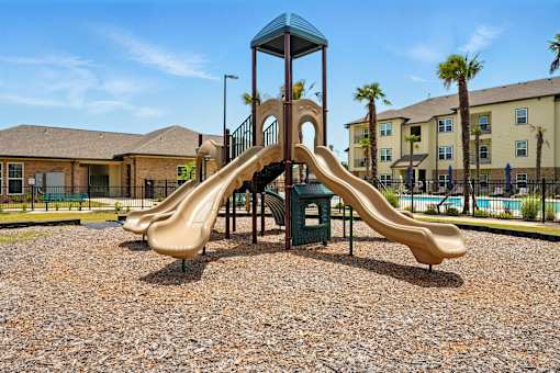 A playground with a slide and a tower. at Beau Chene Lake Charles Apartments, Los Angeles, 70605