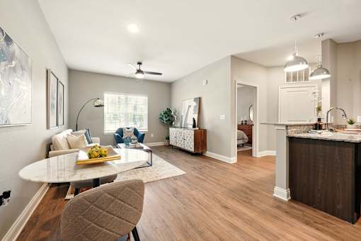 A modern kitchen with a dining table and chairs. at Beau Chene Lake Charles Apartments, Lake Charles