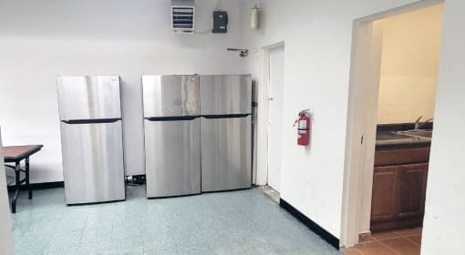 a kitchen with two refrigerators and a fire hydrant at Clinton Towers, New York