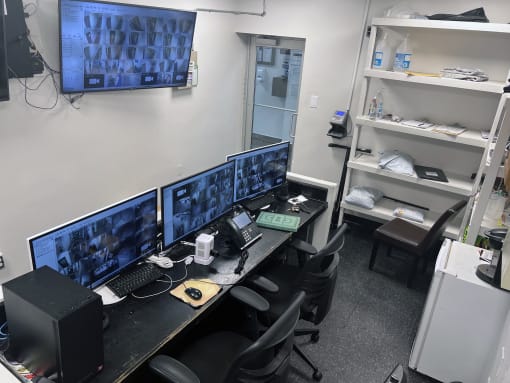 an office with four computer monitors on a desk at Clinton Towers, Bronx, NY, 10457