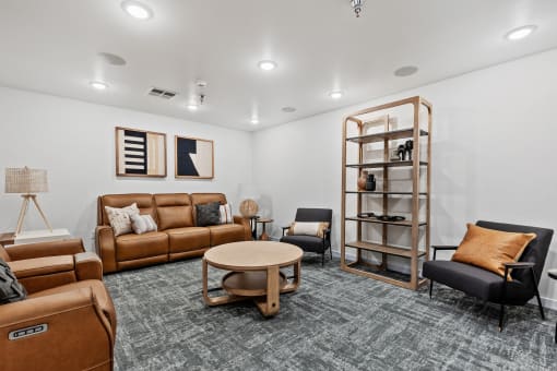 a living room with couches and chairs and a table