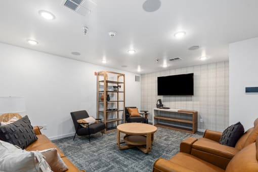 a living room with couches and chairs and a tv