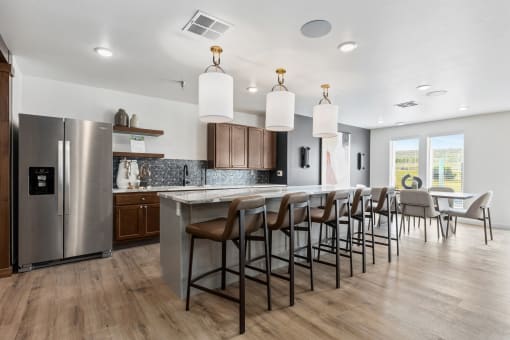 an open kitchen and dining area with a large island and chairs