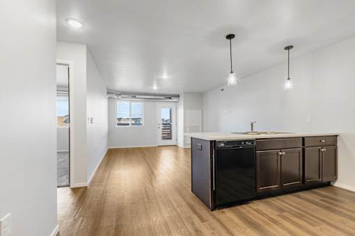 A kitchen with dark wood cabinets and a white countertop.