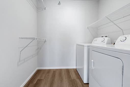 A white laundry room with a washer and dryer.