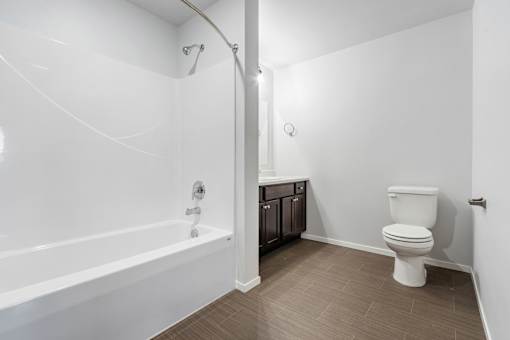 A white bathroom with a toilet and a bathtub.