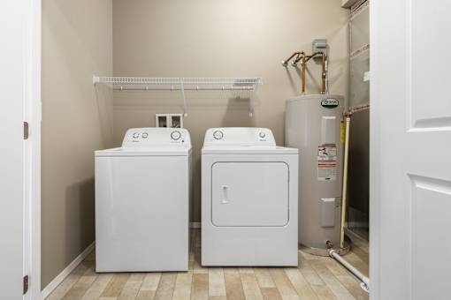 A white washer and dryer in a small laundry room.