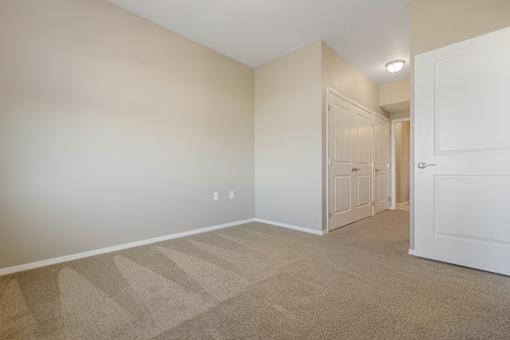 A room with a carpeted floor and white walls.