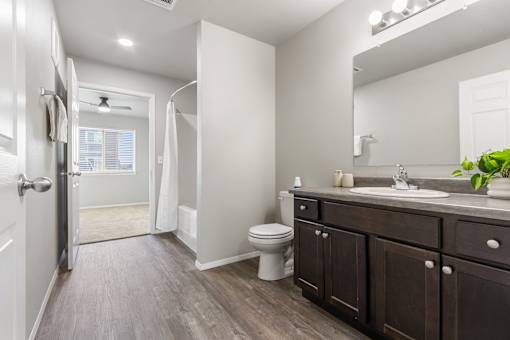 A bathroom with a toilet, sink, and a walk-in shower.
