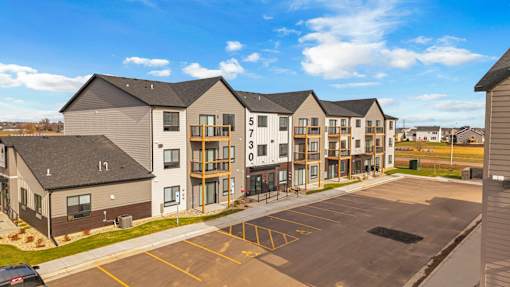 Apartment complex with numbered doors on the side.