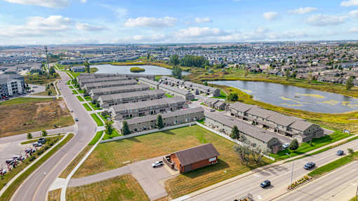 A large building complex is situated next to a body of water.