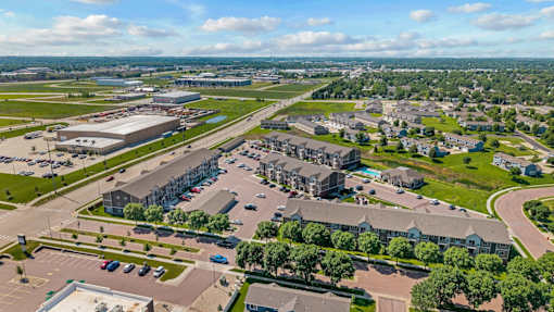 A large aerial view of a city with a mix of buildings and green spaces.