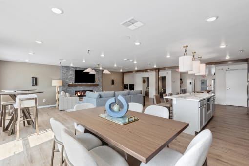 a living room and dining room with a table and chairs