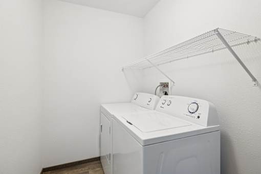 A white washing machine in a laundry room.
