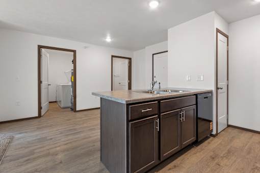 A kitchen with brown cabinets and a white countertop.