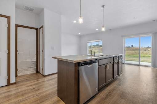 A kitchen with a large island and stainless steel appliances.