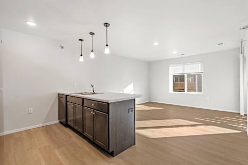 A kitchen with a sink and cabinets is shown.