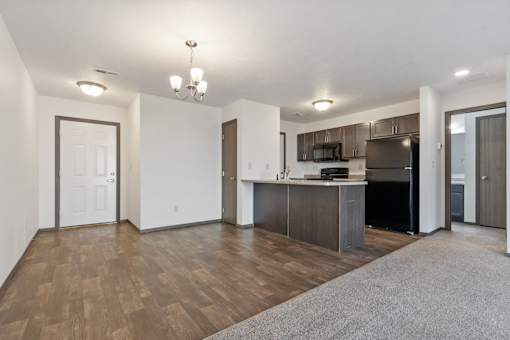 A kitchen area with a refrigerator, microwave, and oven.