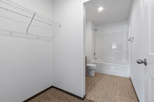 A white bathroom with a toilet, sink, and bathtub.