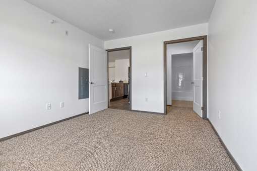 A room with a carpeted floor and white walls.
