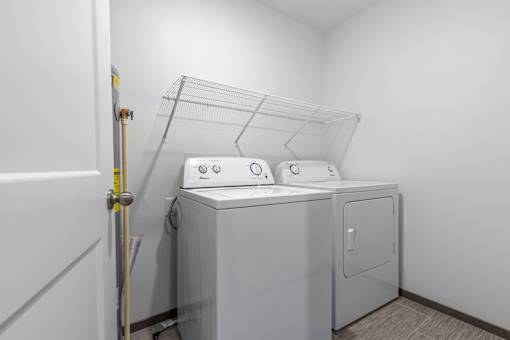 A white washing machine and dryer in a small laundry room.