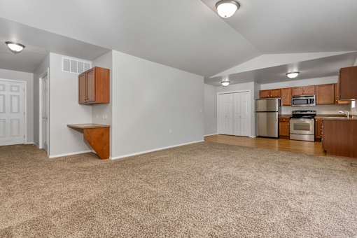 A kitchen area with a refrigerator, microwave, and oven.