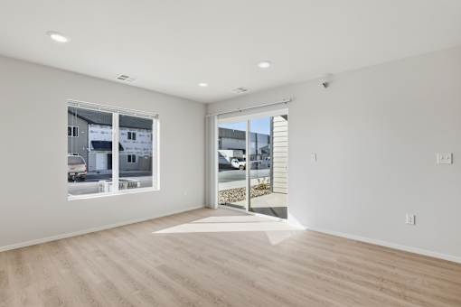 A room with a large window and a sliding glass door.