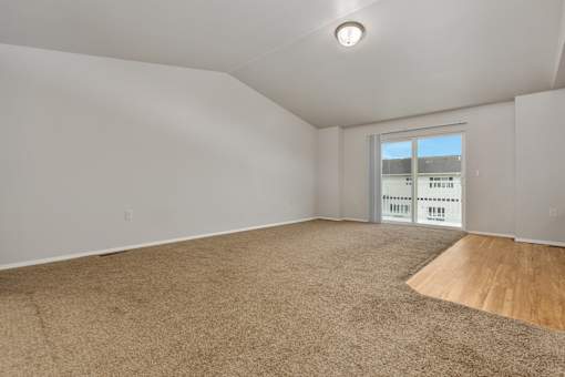 Empty room with carpeted floor and a window.