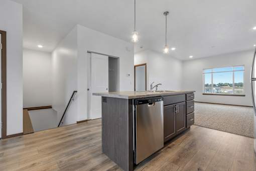 A modern kitchen with a large island and stainless steel appliances.