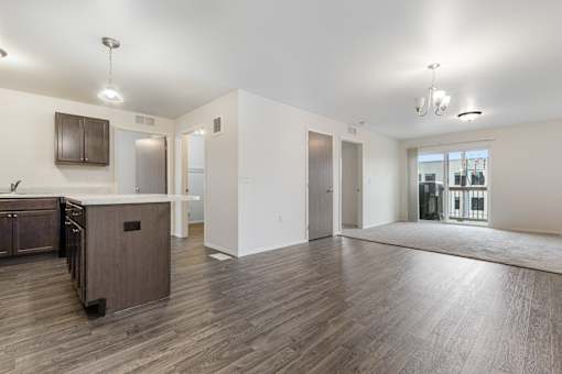 A spacious kitchen with wooden floors and a large island.